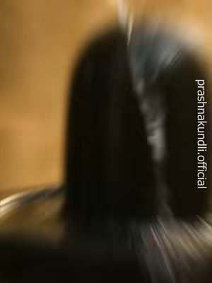 The image has a dark, blurred abstract composition. It appears to depict a Shivling, with a soft focus effect that creates an impression of movement or a spiritual aura. The majority of the image is taken up by a dark, elongated shape, likely representing the Shivling itself. The background is a warm, sepia tone.