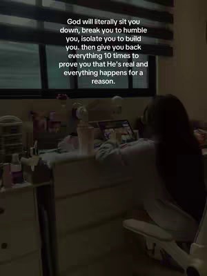 The image shows a person sitting at a desk, facing away from the camera, focused on their computer screen. The setting appears to be a room with a window, as suggested by the blinds in the background. Text overlay provides inspirational quotes.