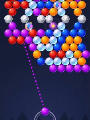 The cover image shows a simplified bubble shooter game interface. The background is a dark blue, with a pattern of silhouetted triangular shapes at the bottom, suggesting a night sky. Colorful bubbles are arranged in a pattern at the top of the screen, with a targeting line extending towards a single purple bubble at the bottom. The bubbles include various colors like red, orange, blue, purple, and white. The gameplay is implied to be centered around matching similar bubbles.