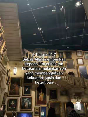 The image features a detailed interior shot of a building, possibly a museum or library, filled with numerous framed paintings. The architecture includes a wooden staircase and overhead lighting, suggesting a vintage or themed setting. A bible verse is overlaid in a white font with a black outline, adding a layer of religious context to the visual.