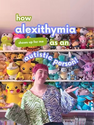The cover image shows a person with pink hair standing in front of shelves densely packed with plush toys of various characters. The person is smiling and has their arms open wide. Overlaying text includes "how alexithymia shows up for me", positioned at the top. The overall composition is colorful and inviting.