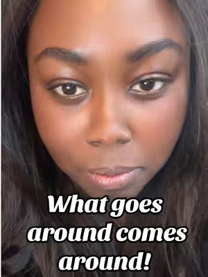 A close-up shot features a woman with brown skin, dark, wavy hair, and dark eyes gazing directly at the camera with a thoughtful expression. The image has text overlayed. Below or at the chin of the girl in dark bold text  written "What goes around comes around!". The image is well-lit, with a neutral background. The composition is simple but the close-up focuses attention on the woman's face.