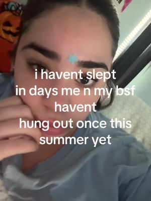 A selfie-style image taken from a close angle shows the upper half of a person's face. The individual, with a fair complexion, is positioned slightly off-center, looking directly at the camera. Their eyebrows are well defined, and their dark hair is pulled back. The person's left hand is brought up to their face as if they are resting their head on their hand. The background is blurred, suggesting an interior setting. A text overlay in white font is superimposed on the image. The overall composition is simple, with the focus primarily on the person's face and the overlaid text.