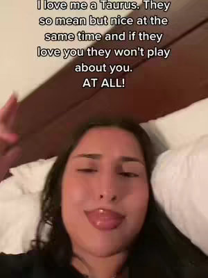 A selfie-style video cover image. The image is a close-up of a woman lying in bed, partially visible. The woman has dark hair and is looking at the camera with her tongue out and eyes closed. There is text overlayed at the top of the image, which appears to be a quote.