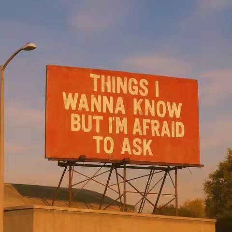 An orange billboard with the words 'THINGS I WANNA KNOW BUT I'M AFRAID TO ASK' in white text is set against a blue sky. The billboard is supported by a metal structure and sits atop a concrete structure. A street lamp is visible on the left side of the image, and some foliage is visible on the right side.