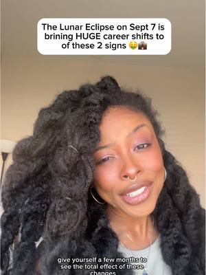 A selfie-style video cover image featuring a Black woman with long, curly hair and makeup. She's smiling and looking towards the camera, with a text overlay at the top in a rounded rectangle that reads, "The Lunar Eclipse on Sept 7 is brining HUGE career shifts to of these 2 signs" The background is a neutral color.