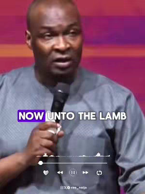 A man with short hair, wearing a gray shirt, is holding a microphone and speaking. Text overlayed includes audio controls and a caption labeled "NOW UNTO THE LAMB". The background appears to be a blurred purple color.