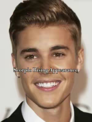 The cover image features a medium shot of Justin Bieber with text overlayed. Bieber is smiling, wearing a dark blazer over a white collared shirt. The background is a plain white or light-colored surface. Overlayed in the center is the text 'Scorpio Rising Appearance'.