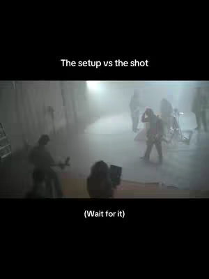 A foggy, indoor shot shows a film set with crew members and equipment. The foreground features a person holding a camera. In the background, figures are interacting amidst the haze, illuminated by a bright light, creating a sense of anticipation and suspense typical of behind-the-scenes content.