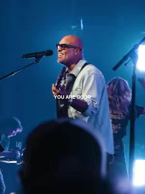 The cover image features a live performance with a bald man in sunglasses playing a guitar and singing into the microphone. Text overlayed on the image reads "YOU ARE GOOD". The lighting is dramatic, with blue hues and spotlights.