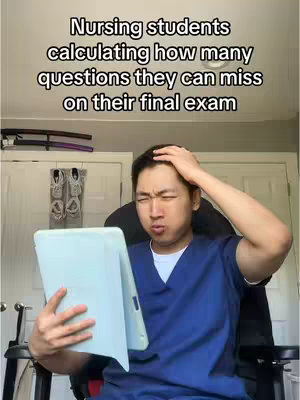 A young Asian man is sitting in a black office chair and holding a blue tablet. He is wearing a blue scrub top, and has an expression of concern, with one hand on his head. Text at the top reads: Nursing students calculating how many questions they can miss on their final exam.