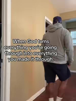 A man in a gray hoodie and dark shorts walks away from the camera through a doorway, with text overlaid. The background is a room with light-colored walls and a wooden door frame.