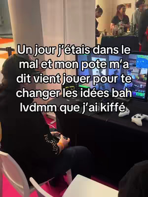 A person is sitting in front of a screen playing a game. The image is a vertical shot, typical of a video. The text overlay in white over the image informs the viewer that the image is about a moment a man felt down and his friend encouraged him to play a game to change his mind.