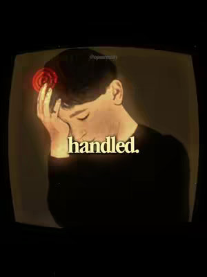 A stylized image with a person, likely male, in profile inside a display screen-like frame. The person has their hand on their head and is holding it. A glowing red element, resembling a stylized flower or energy burst, appears above their head. The image is dimly lit with a warm, sepia tone, and the text 'handled.' is overlaid in a bold, cream-colored font.