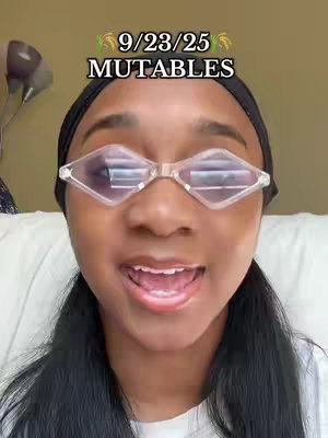 A young woman with dark hair and a black headband is wearing uniquely shaped glasses and smiling widely. Above her is text with the date and the word "MUTABLES".