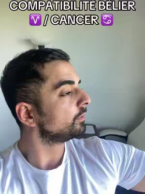 A medium shot of a man in a white t-shirt, facing left. The background is blurred. Text at the top reads in white and purple the topic of zodiac compatibility.