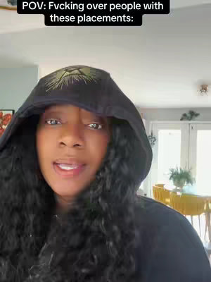 A woman in a black hoodie looking at the camera. The hood is up, and text appears at the top, likely the video title.