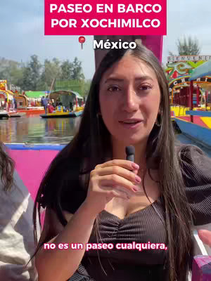 The cover image shows a woman speaking into a microphone with a body of water and boats in the background. Text overlays at the top and bottom of the image provide context.