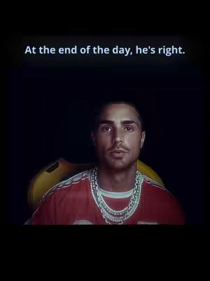 A man with a focused expression is the central figure, adorned with a silver necklace and a red and white striped shirt. The background is a simple black void, with the words 'At the end of the day, he's right.' in white text at the top.