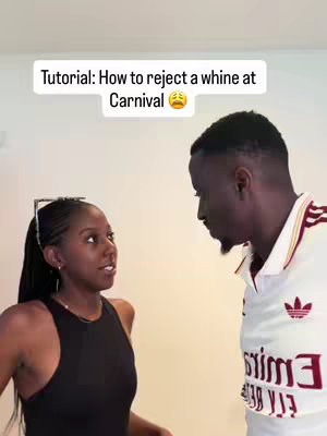 The cover image shows a woman and a man facing each other indoors. Text overlaid on the top of the image reads "Tutorial: How to reject a whine at Carnival", with a sad face emoji next to the word "Carnival". The woman is on the left, wearing a black tank top, and has her hair in braids. The man is on the right, with his back to the camera, and a white shirt with what appears to be a soccer jersey in the back. The background seems to be a plain white wall.