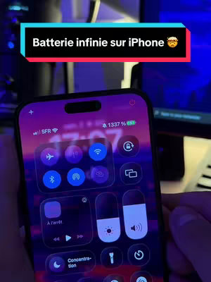 The cover image shows a close-up of a smartphone screen displaying the control center with various settings and a high battery percentage (1337%). Above the screen is a black and colored bar containing text. The background is blurred but appears to be a desk setup with screens.
