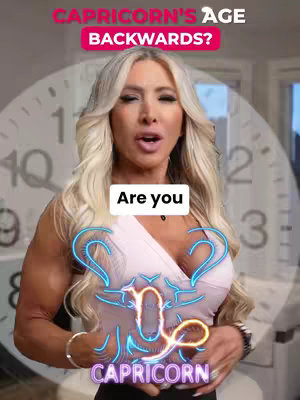 A woman with long blonde hair stands in front of a blurred clock face. Text overlays read "CAPRICORN'S AGE BACKWARDS?" in a pink band and "Are you" in a white box above a neon-lit Capricorn symbol.