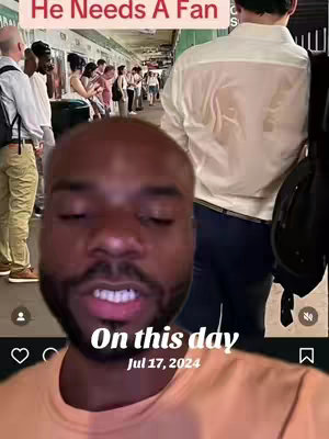 The cover image is a selfie-style shot with the face of a Black man in the foreground. Below the man is text. Behind him, a slightly out-of-focus background reveals a subway or train station scene with other people. Above the man's head is text laid over the image in a white font, and the date is featured towards the bottom center of the frame in the white font with a rounded font.