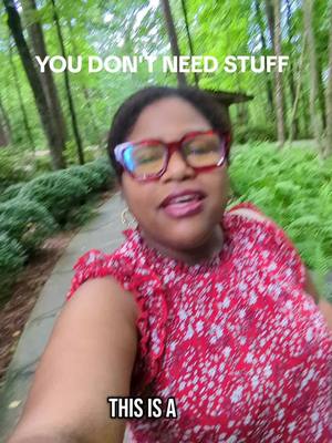 A smiling woman with glasses is walking towards the camera, with greenery in the background and text overlays.