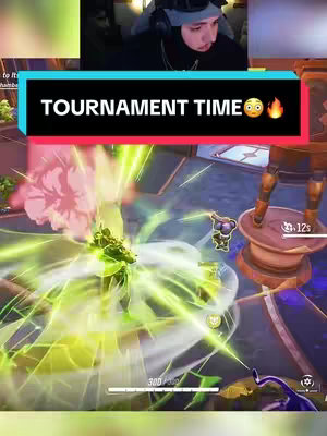 The cover image shows a split-screen in a vertical format. The top section features a person wearing a hat and headphones looking at the camera, suggesting a streamer or gamer. The bottom section displays in-game footage from a video game, depicting a character in action. Superimposed across the middle is a text overlay that reads “TOURNAMENT TIME” along with an emoji.