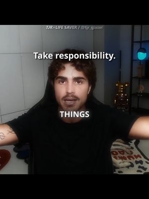 A man with dark hair and a beard is centered in the frame, seated in a black gaming chair. Above him, overlaid text reads 'Take responsibility.', and below him 'THINGS' is displayed. The background is softly lit, with some subtle hints of decor.