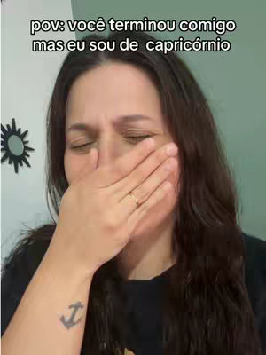 The cover image is a close-up shot of a woman's face. She is covering her mouth with her hand, eyes closed, conveying a feeling of upset. A background element includes a decorative star-like design. The overall color palette is neutral with the woman wearing a dark t-shirt.