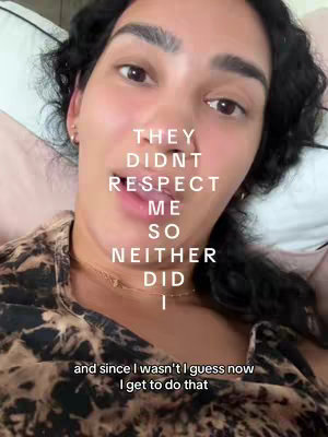 A selfie-style shot featuring a woman lying in bed, with text overlaid on her picture. The background shows pillows, suggesting a bedroom setting.