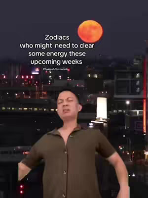 The cover image features a man in the foreground against a nighttime cityscape backdrop. Behind the man, the sky transitions from dark blue to black, with a large orange moon. Text overlayed on the top of the image says, 'Zodiacs who might need to clear some energy these upcoming weeks.' The man is wearing a collared shirt, with his facial expression appearing slightly concerned.