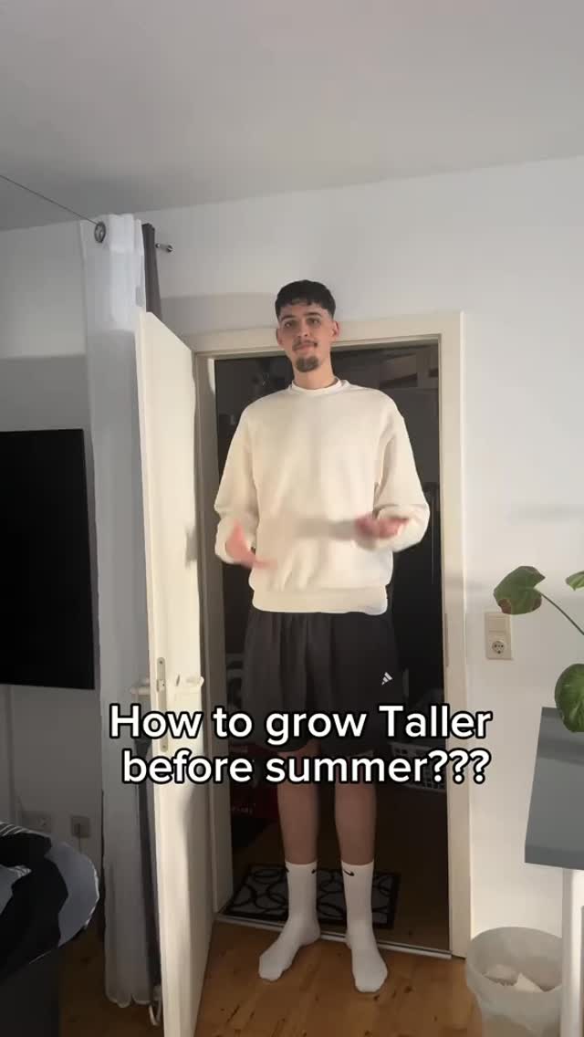 The cover image shows a man standing in a doorway. He is wearing a white sweatshirt, black shorts, and white socks. Text overlayed on the image reads "How to grow Taller before summer???"