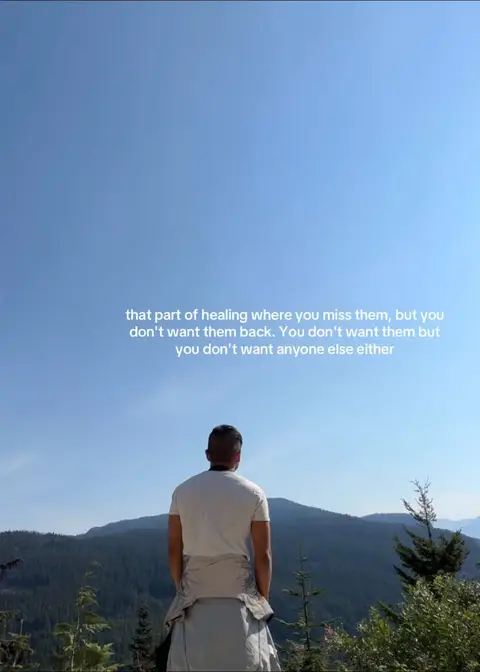 A man is seen from the back, standing on a hill, looking towards a mountainous landscape under a clear blue sky. Text overlayed on the image describes a stage of healing.