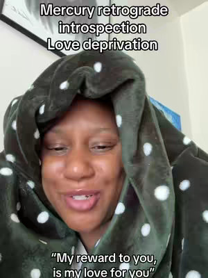 The cover image is a selfie of a person wearing a green, polka-dotted hooded blanket, with the person's face visible. Overlaid at the top are the words 'Mercury retrograde introspection Love deprivation,' and at the bottom, the text reads "My reward to you, is my love for you."