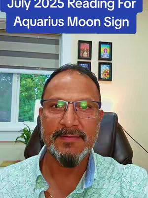 A man with glasses and a beard is positioned in front of a window and some pictures hanging on a wall. Above the person's head is a banner that says "July 2025 Reading For Aquarius Moon Sign."