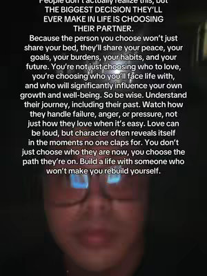 A dimly lit selfie-style image with a person at the bottom wearing glasses. Text fills most of the frame with a message about choosing a life partner.