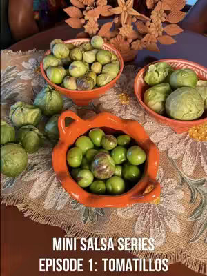 The cover image features a table setting with various bowls filled with green tomatillos. The composition is dominated by the vibrant green color, complemented by the orange hues of the bowls and a patterned tablecloth. The layout is well-arranged, with the bowls serving as the primary visual focus.