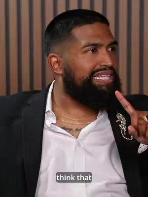 A man with a short haircut, beard, and a white shirt speaks, with the text "think that" overlaid near the bottom.