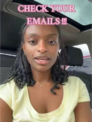 A selfie-style video shot inside a car. The person in the image is a Black woman with long black braids, a yellow shirt, and a small gold necklace. The background shows the car's interior, including the open sunroof. Overlayed text reads, 'CHECK YOUR EMAILS !!!' in a pink, bubble font.