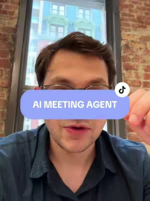A man with glasses is indoors in front of a partially visible window with a light blue sky peaking through. The creator covers his face partially with the sign that states 'AI MEETING AGENT'. There is a tiktok icon in the top right corner of the covered sign.