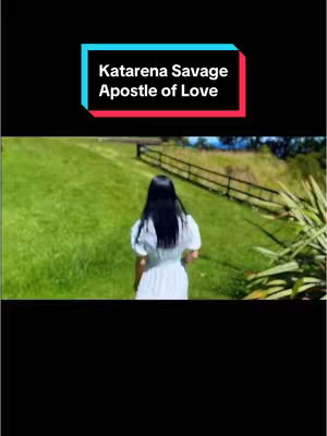 A woman walks away from the camera on a grassy hill, with a fence and trees in the background. Text overlayed on top of the image at the top, inside a rectangular shape with white text on a black background.