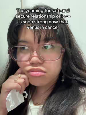 A young woman with long dark hair and glasses is shown from a medium close-up, gazing slightly off-camera with a thoughtful expression. Text overlays the image, and she's resting her cheek on her hand.