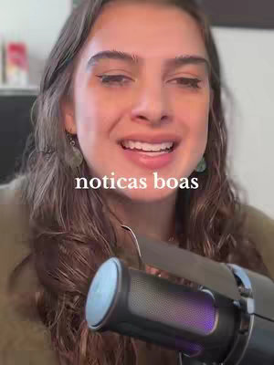 A woman with long brown hair is smiling and speaking into a microphone in the bottom right corner. Text overlay 'noticias boas' is in the mid-ground.