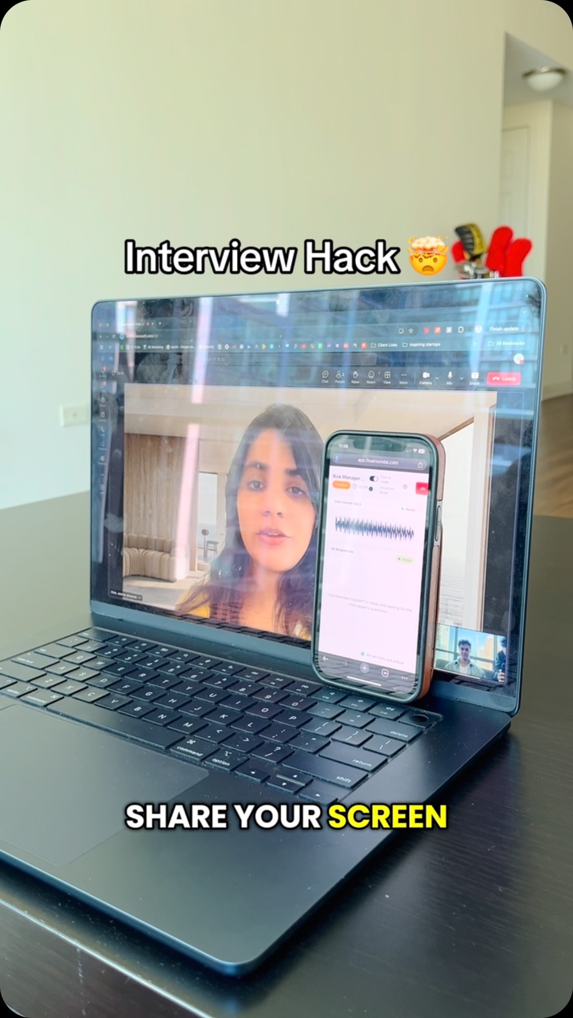 A person is seen on a laptop screen, sharing their screen, with their phone displaying an app about interviews, and text overlays.