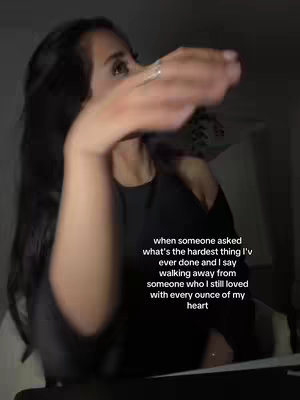 The cover image features a person with long black hair, viewed from the shoulders up. The person has their arm raised, with their hand near their face, as if gesturing. The background is dark with text overlayed on the image.
