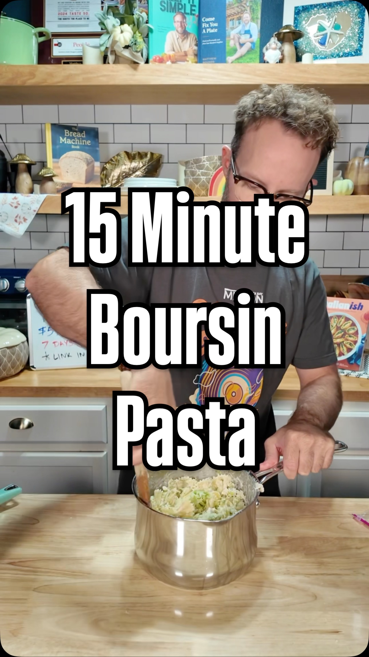 The image shows a man in a kitchen, holding a pot of pasta with a wooden spoon. The overlay text says "15 Minute", "Boursin", and "Pasta". The background has shelves with various items, including cookbooks.