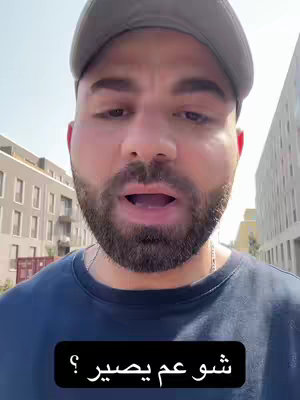 A man wearing a gray cap and dark blue t-shirt is the main subject of this video cover. He is standing outside against a blurry, bright background. A text overlay sits prominently at the bottom of the shot.