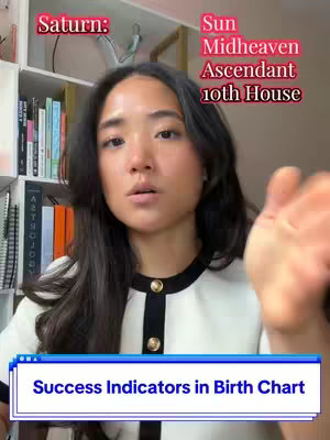 An Asian woman looks directly towards the viewer, with overlaid text in the background referencing astrological terms. In the foreground, the woman's hand is extended as if making a point. The image has a vertical layout, and the background features a bookshelf and some decor.